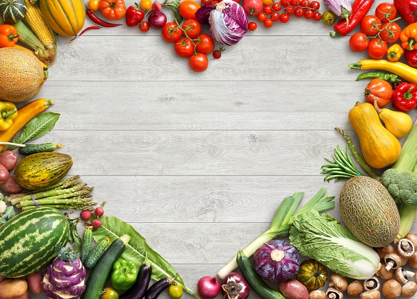 Heart shaped food. Food photography of heart made from different fruits and vegetables on white wooden table. Copy space. High resolution product